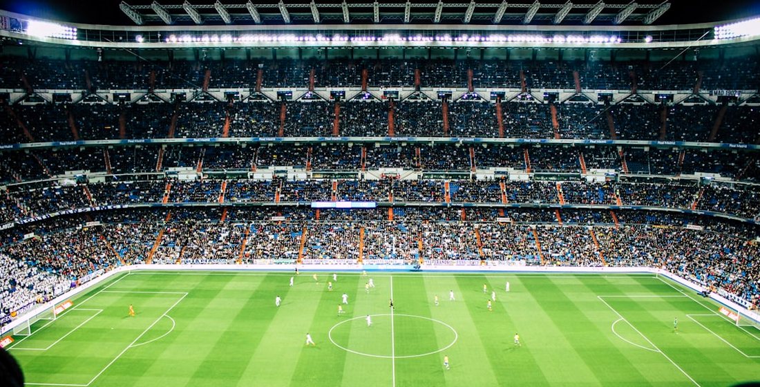A packed football stadium under floodlights, streamed live in 4K on Zoryflix